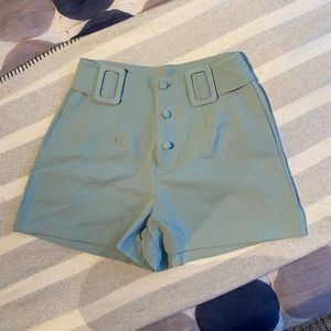 Cider mini shorts. mint green size xs. button and belt detailing in front.